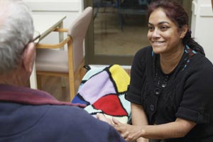 Lady holding the hand of an older gentleman