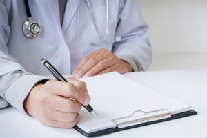 Doctors hand writing on form