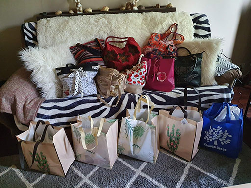 Twenty handbags containing personal care items, known as Share the Dignity bags