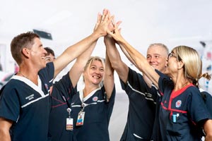 A group of health professionals high-fiving